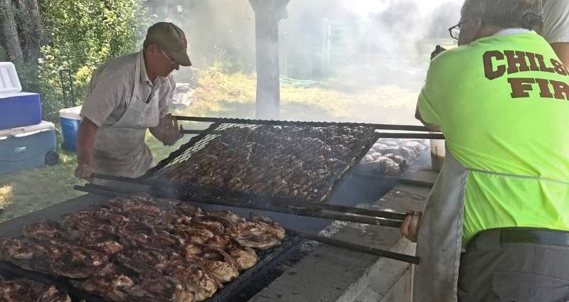 Firemen cooking chicken at Chilson Fire Department Chicken BBQ